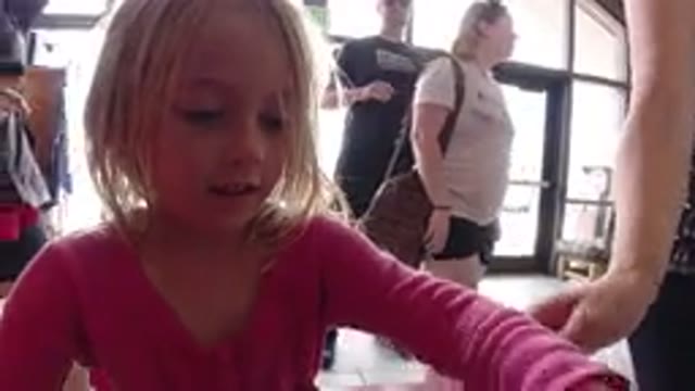 WINTER PARK COLORADO-2019: A Child Making A Stamp With Her Parents In A Place