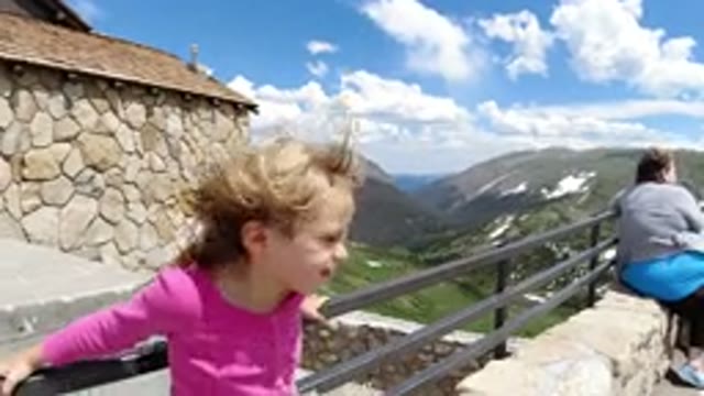 WINTER PARK COLORADO-2019: Blond Child Views Mountains From A Panoramic Deck Of