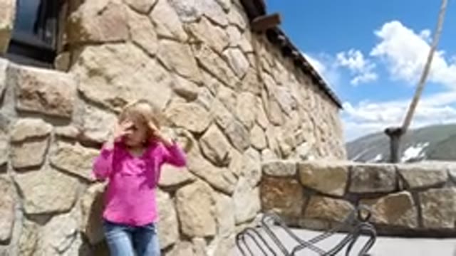 WINTER PARK COLORADO-2019: Little Girl Walking Around A House Made Of Rocks With
