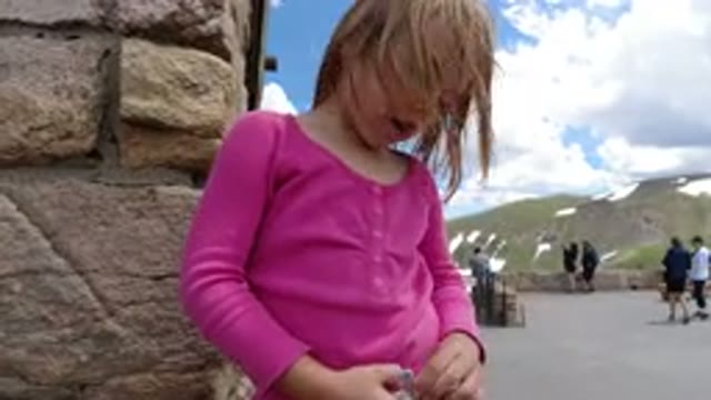 WINTER PARK COLORADO-2019: Little Girl Chatting at Outdoor Tourism Attraction