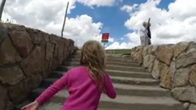 WINTER PARK COLORADO-2019: Girl Walking Up A Set Of Stairs While Two Older