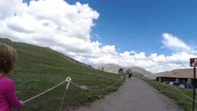 WINTER PARK COLORADO-2019: A Girl Walking Hill Path Holding Rope