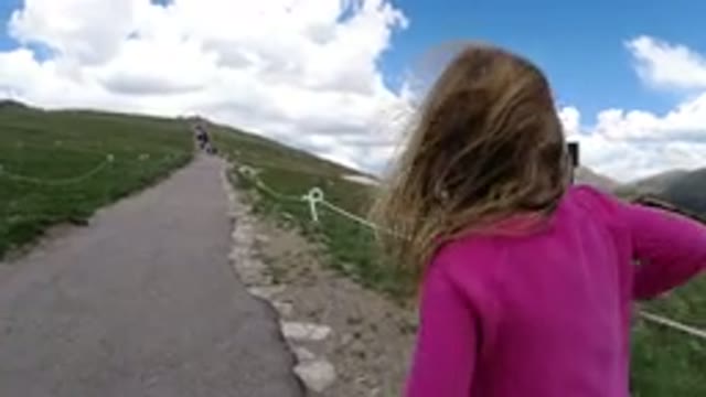 WINTER PARK COLORADO-2019: A Girl Walking in the Two Sides Covered with Grass