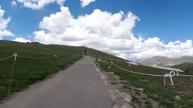 WINTER PARK COLORADO-2019: A Girl Walking Uphill On A Long Narrow Path