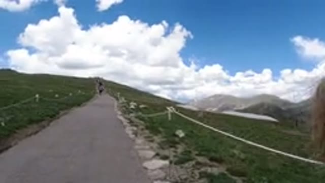 WINTER PARK COLORADO-2019: Walking Mountain Climb Up Rope Through Grass Path With Clouds