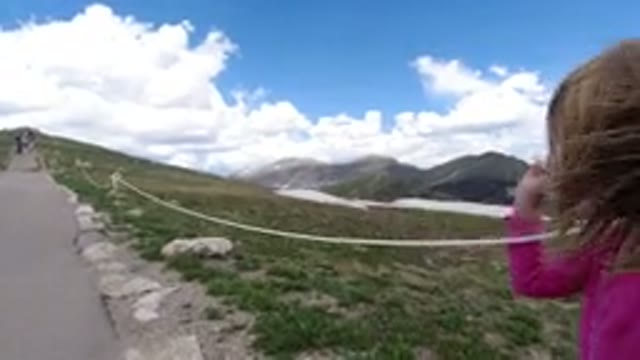 WINTER PARK COLORADO-2019: Little Girl Traveling Down A Paved Trail Holding Onto Rope