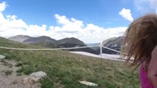 WINTER PARK COLORADO-2019: Child Girl Climbing A Hill On A Trail With A Field