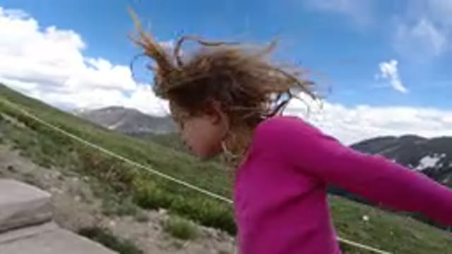 WINTER PARK COLORADO-2019: Young Girl In Pink Shirt Walks Up Stone Steps On A