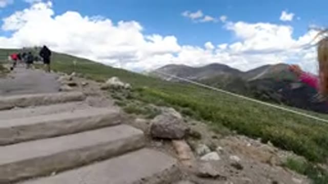 WINTER PARK COLORADO-2019: Child Climbing Steps On A Green Mountain Going After