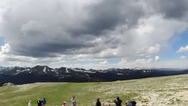 WINTER PARK COLORADO-2019: A Gathering Of People On A Hilltop Looking At Cloudy