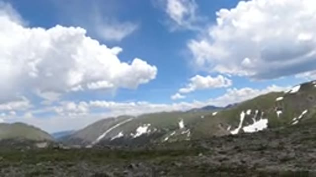 WINTER PARK COLORADO-2019: Green Mountains Partially Covered With Snow And A Sky