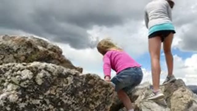 WINTER PARK COLORADO-2019: Girl Climbs And Explores Rocks Around Other People