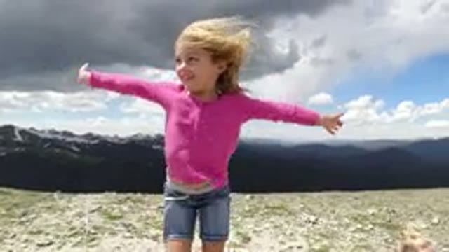 WINTER PARK COLORADO-2019: A Little Girl Smiling And Feeling The Effects On The Hilltop