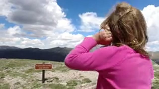WINTER PARK COLORADO-2019: Girl On A Windy Day In Nature Watching The View Of Mountains