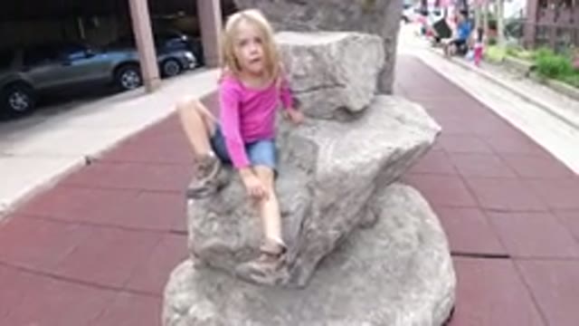 WINTER PARK COLORADO-2019: Little Blonde Girl In The Plaza Showing Parent Her