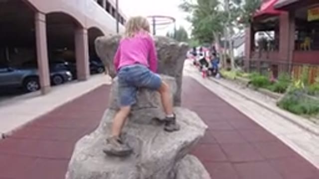 WINTER PARK COLORADO-2019: A Girl Trying To Sit On A Rock