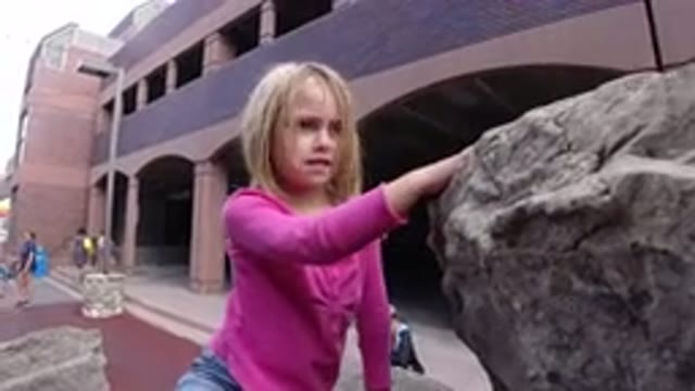 WINTER PARK COLORADO-2019: Little Girl Climbing On Top Of Large Rocks And