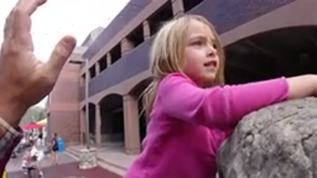 WINTER PARK COLORADO-2019: Blonde Girl Climbing A Small Monument On The Street