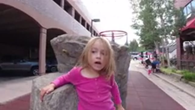 WINTER PARK COLORADO-2019: Little Girl Messes Around And Tries To Sit On Stone