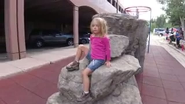 WINTER PARK COLORADO-2019: A Child Posing For A Photo While Other People Are Walking