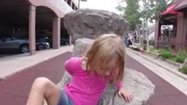 WINTER PARK COLORADO-2019: A Young Female Positions Herself On A Rock On A Sunny