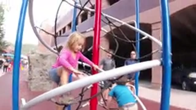WINTER PARK COLORADO-2019: A Little Girl Playing On A Jungle Gym Set With
