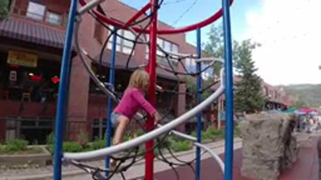 WINTER PARK COLORADO-2019: Little Girl Plays Alone In The Small Playground
