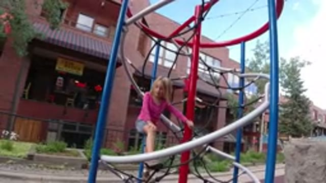 WINTER PARK COLORADO-2019: Little Girl Playing Alone on Snowy Playground