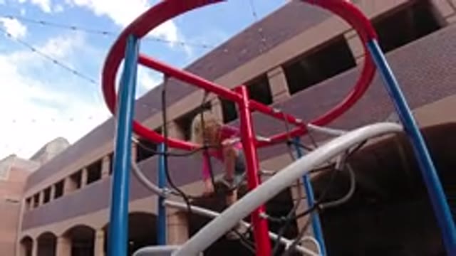 WINTER PARK COLORADO-2019: A Kid Is Climbing A Structure At A Playground On A