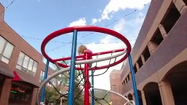 WINTER PARK COLORADO-2019: Young Kid Climbing On Metal Red Blue And White