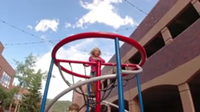 WINTER PARK COLORADO-2019: Kids Playing On Playground Showing Buildings And Sky