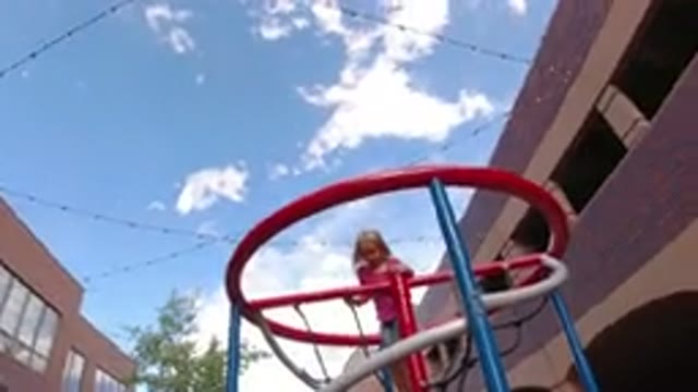 WINTER PARK COLORADO-2019: Two Children Climbing A Jungle Gym In A