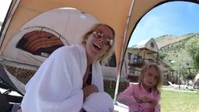 WINTER PARK COLORADO-2019: Mom And Daughter In Swimsuits Sitting Outside Under Canopy