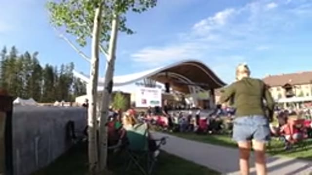 WINTER PARK COLORADO-2019: Families Gathering At An Outdoor Concert Under A Blue Sky