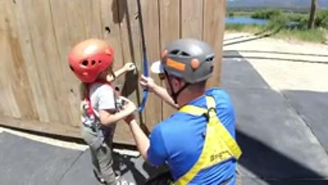 WINTER PARK COLORADO-2019: Little Girl Excited To Start Rock Climbing With Father