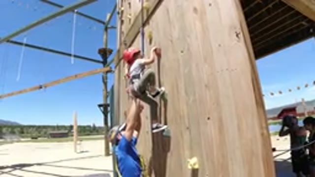 WINTER PARK COLORADO-2019: An Adult Teaching A Kid To Rock Climb On A Wall