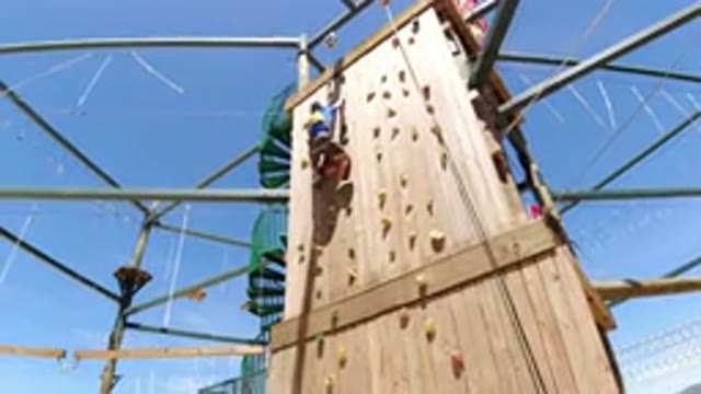 WINTER PARK COLORADO-2019: Girl Rock Climbing A Large Wall Very Slowly