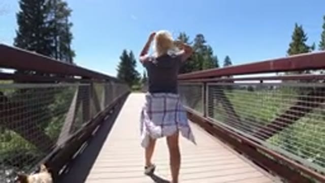 WINTER PARK COLORADO-2019: Woman And Her Dog Walking On A Bridge