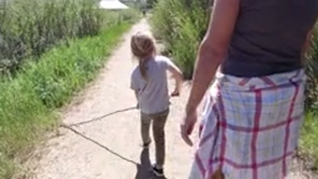 WINTER PARK COLORADO-2019: People Are Walking On A Trail With Tall Grass And