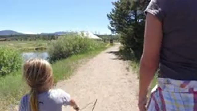 WINTER PARK COLORADO-2019: Little Blonde Girl Walking Outside On A Dirt Trail