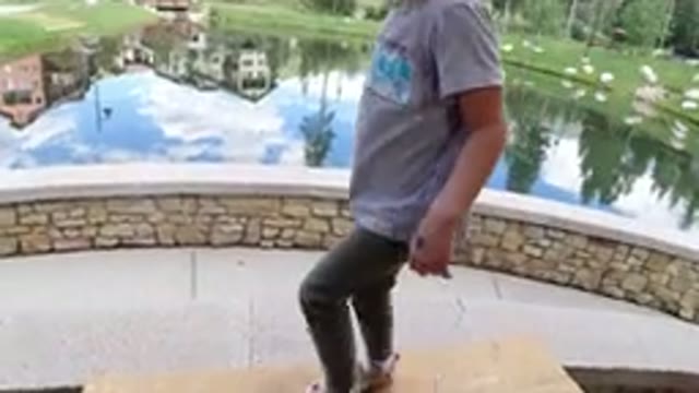 WINTER PARK COLORADO-2019: A Blonde Girl Jumps From A Small Table Onto A Rock