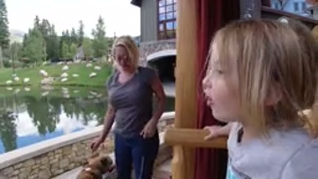 WINTER PARK COLORADO-2019: Woman Holding A Dog On A Leash Attempting To Help Child