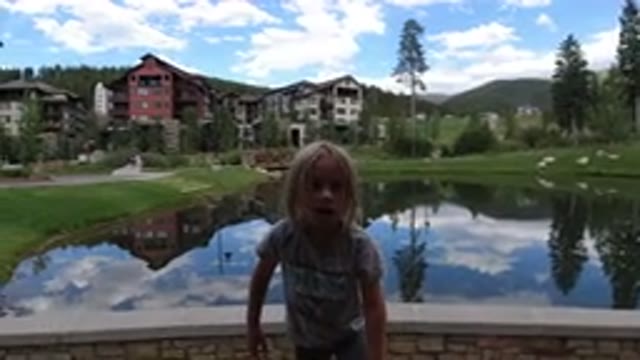 WINTER PARK COLORADO-2019: Girl Enjoying Playing in Front of Lake Near Houses