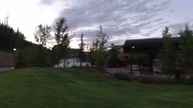 WINTER PARK COLORADO-2019: People Watching TV Screen Board In Open Parking Lot