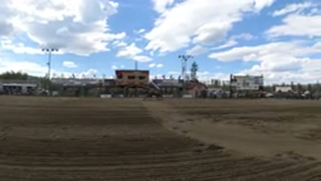 WINTER PARK COLORADO-2019: A Man Rides a Brown Horse in a Sandy Outdoor Game