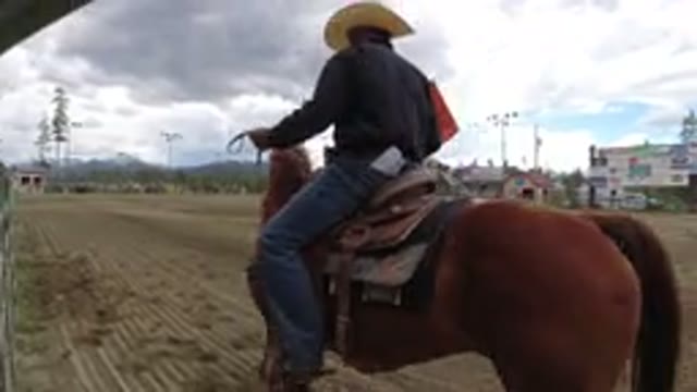 WINTER PARK COLORADO-2019: A Man Wearing A Hat Is Riding A Horse On A Dirt Track