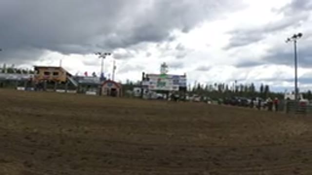 WINTER PARK COLORADO-2019: Two Men On Horses Chase Large Dog Around A Muddy Arena