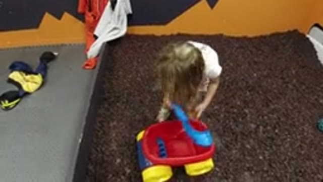 WHEAT RIDGE COLORADO-2019: Girl Pulling Wagon in Her Bedroom While Wearing Shoes