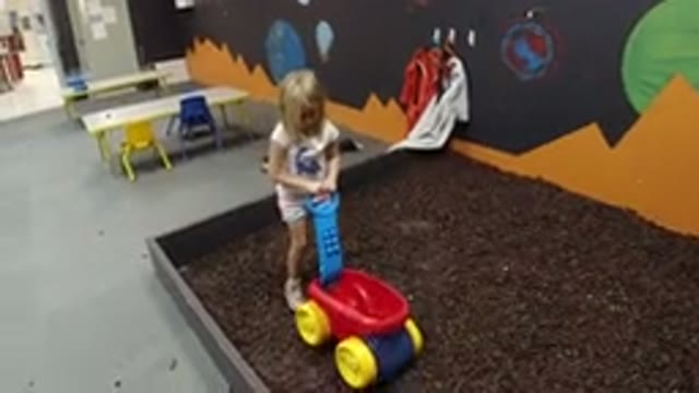 WHEAT RIDGE COLORADO-2019: A Little Girl Is Playing Alone With Her Toy In A Play