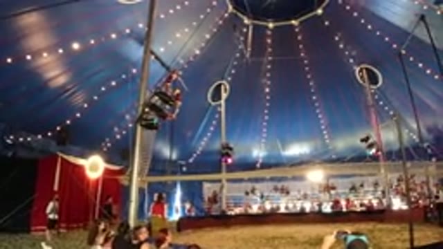BROOMFIELD COLORADO-2019: Two People In A Circus On Swings In A Blue Tent